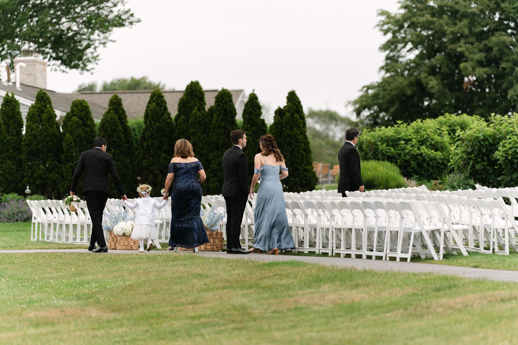 Guests arriving and finding their seats before an outdoor ceremony