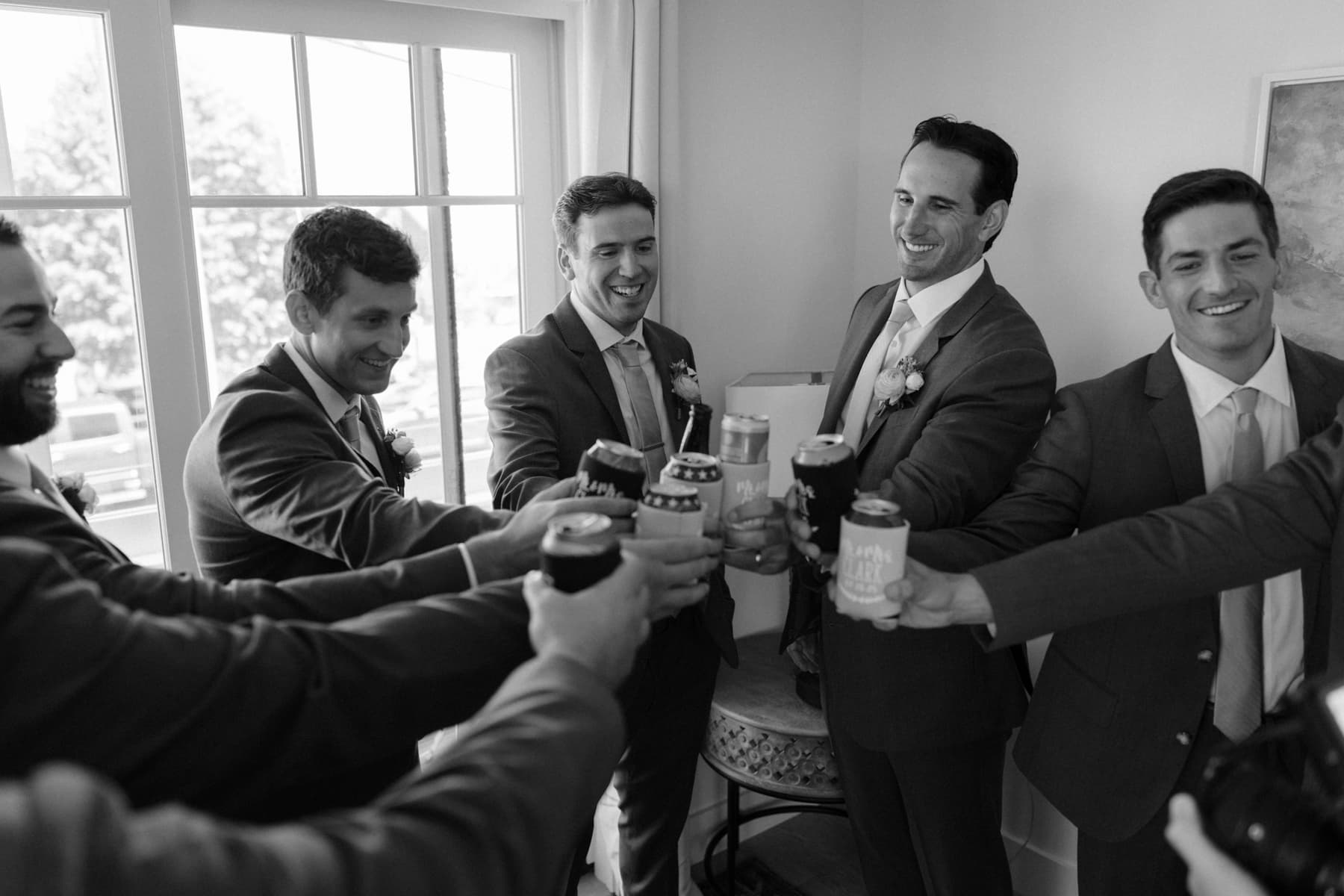 Groomsmen sharing a toast while getting ready in the morning