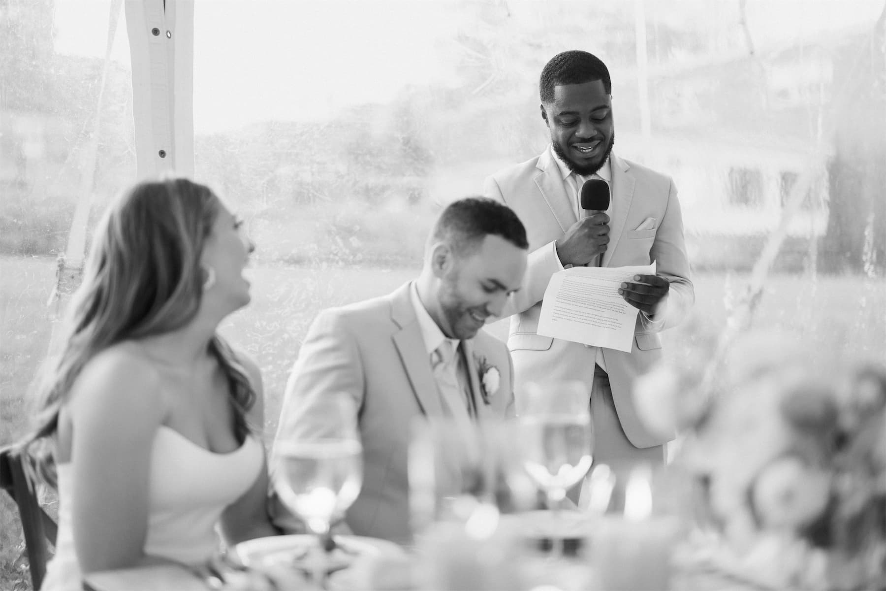 A best man giving a toast in golden evening light